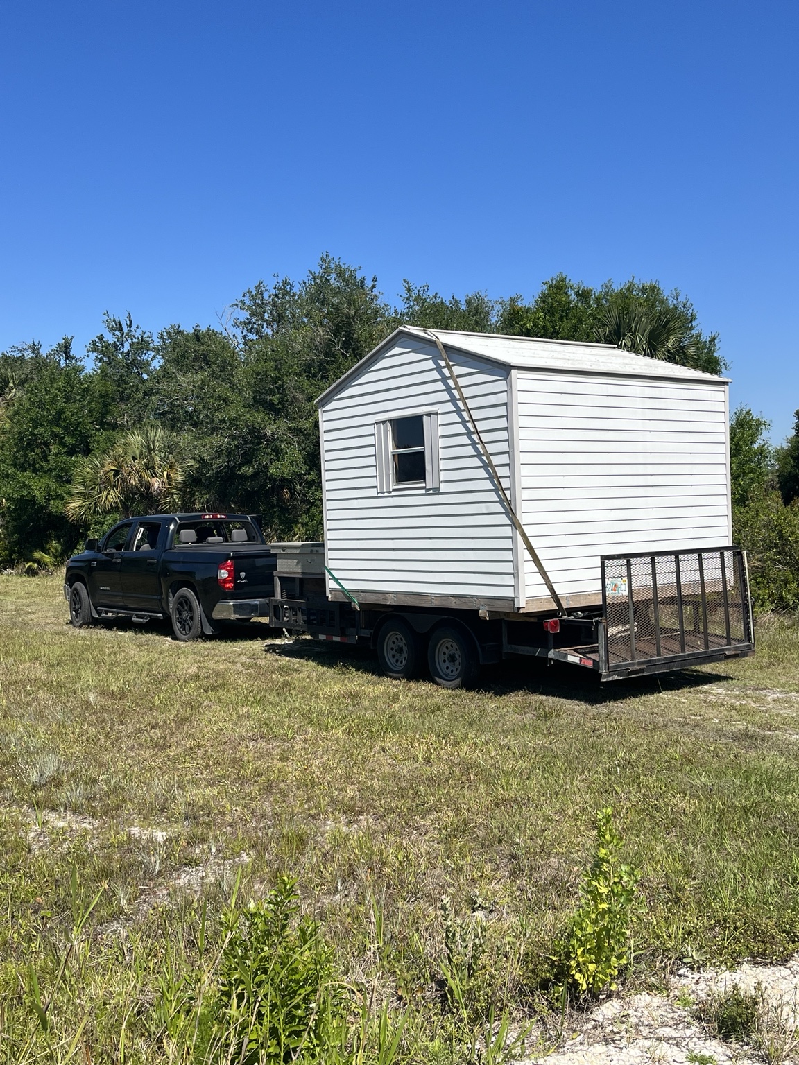 Truck hauling a shed